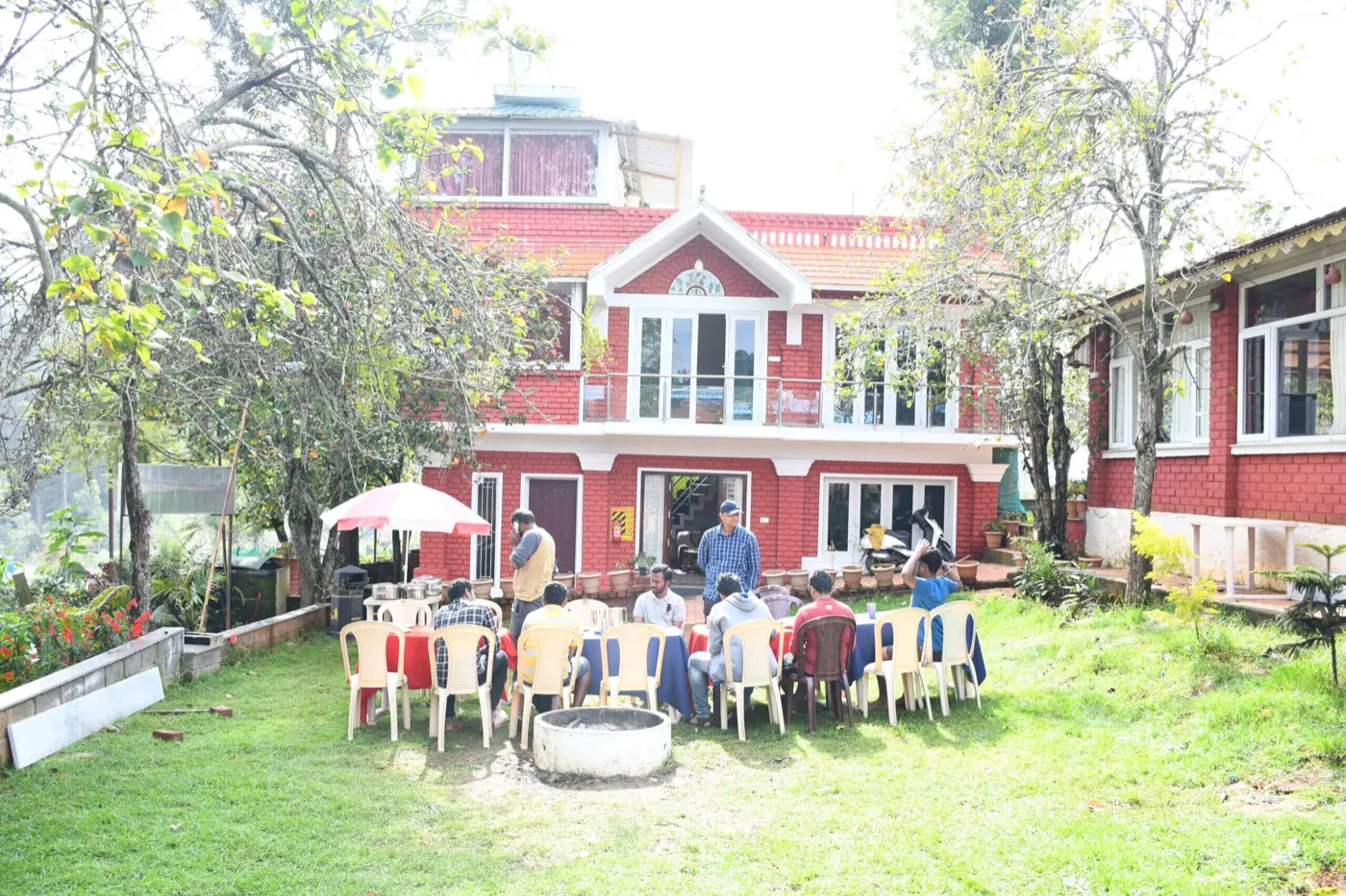 British Bungalow — colonial red bungalow with lawn and guests
